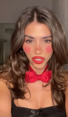 a woman wearing a red bow tie and black bra with pink circles on her face