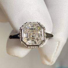 a diamond ring sitting on top of a white napkin