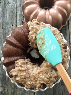 a chocolate bundt cake with a spatula in it next to other desserts