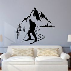 a living room with a couch and a wall decal that has a skier on it