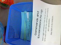 a close up of a sign near a basket with papers in it on a table