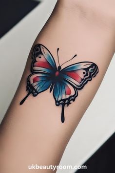 a colorful butterfly tattoo on the left arm and wrist is shown in black, red, and blue colors