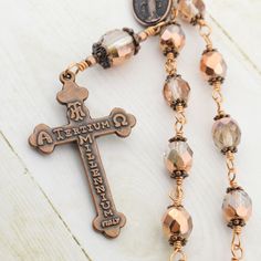 "One decade Catholic rosary beads with Miraculous medal and Eucharistic crucifix. Single decade pocket rosary is made in unbreakable wire wrapped technique with 8mm and 12mm crystal half metallic copper Czech glass beads and antique copper medal and crucifix. Our Czech glass beads are sourced directly from high quality Czech glass factory. All of the materials used in making rosaries are hand picked and undergo utmost quality check. Rosary's length is about 8\" (21 cm) Crucifix: 1.1\"x 1.8\" (2. Making Rosaries, One Decade Rosary, Pocket Rosary, Vintage Rosary, Rosary Beads Catholic, Decade Rosary, Catholic Rosary, Metallic Copper, Rosary Catholic