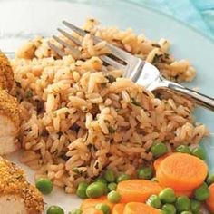 rice, peas and carrots are on a plate with a fork next to it