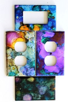 two light switch plates with colorful designs on them