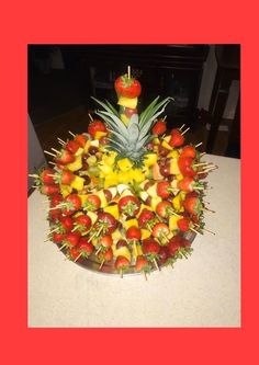 a fruit platter with pineapples, strawberries and bananas