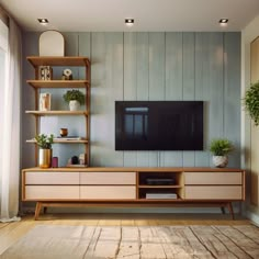 a living room with a large tv on the wall and shelves in front of it