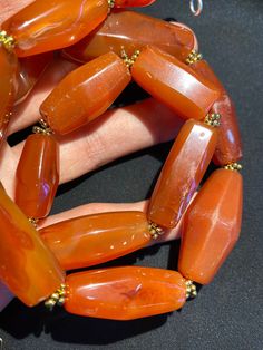 The red color carnelian beads from my collections The origin of this beads from Tibet Himalaya although the carnelian agate can be found in Nepal Pakistan India and Afghanistan as well carnelian agate was used as prayers beads in mala and used as jewelry and amulet as well old agate and carnelian was used as trade items as well in ancient times The age of this beads are more than 1000 years some gold color brass beads are used as spacers very smooth and shinny surface of this beads because of lo Gift Carnelian Faceted Beads, Spiritual Carnelian Beads For Jewelry Making, Hand-strung Carnelian Beads For Jewelry Making, Carnelian Large Beads For Gifts, Orange Agate Beads For Jewelry Making, Carnelian Oval Beads For Jewelry Making, Carnelian Gemstone Oval Beads, Oval Carnelian Beads For Jewelry Making, Oval-shaped Carnelian Natural Stone Beads