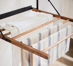 an ironing board with towels hanging from it