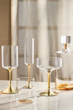 Discover the entire Morgan Glassware Collection by AnthroLiving. Delight dinner guests with a colorful tablescape using this metallic decanter. | Morgan Metallic Decanter by Anthropologie in Gold 1920s Glassware, Colourful Tablescape, Stirred Cocktails, Colored Champagne Glasses, Metallic Glasses, Unique Glassware, Dinner Guests, Dinner Guest, The Morgan