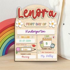 a wooden sign that says lenora first day of kindergartten on it