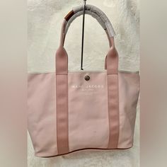 Beautiful Marc Jacobs Tote Bag Nwt Color Light Pink With Brown Leather Accent Size 18x12x7 Big Size Small Hardly Visible Marks 100% Authentic Pink Top Handle Bag For Errands, Pink Shoulder Bag With Dust Bag For Travel, Daily Use Canvas Shoulder Bag With Branded Hardware, Pink Tote Shoulder Bag With Dust Bag, Pink Bag With Top Carry Handle For Errands, Canvas Double Handle Bag With Branded Hardware, Canvas Bag With Branded Hardware And Double Handles, Canvas Bags With Branded Hardware For Everyday Use, Canvas Bag With Double Handle And Branded Hardware