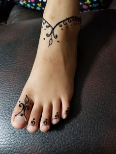 a woman's foot with tattoos on it