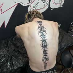 a man with a tattoo on his back