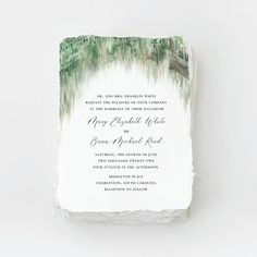 a wedding card with watercolor trees on it