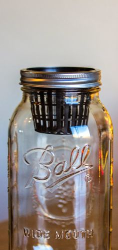 a glass jar with a metal lid on a table