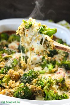 broccoli and cheese casserole being lifted from a white dish with a wooden spoon