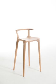 a wooden chair sitting on top of a white floor