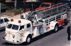 an old fire truck is parked on the side of the road