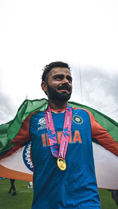 a man with a beard holding up a flag and wearing a medal around his neck