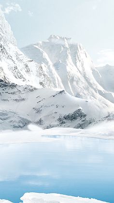 a man riding skis down the side of a snow covered slope next to a body of water