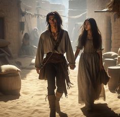 a man and woman dressed in native american clothing walking through an old town with stone buildings