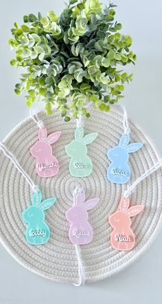 an easter decoration on a wicker tray next to a potted plant