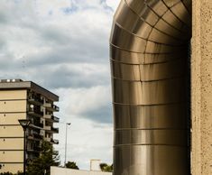 a large metal object sitting on the side of a building