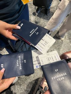 several people are holding their passport cards in one hand and two other hands on the other