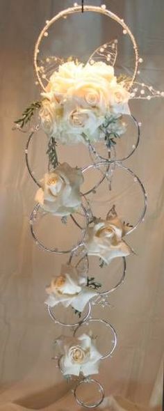 a white flower arrangement hanging from a wire