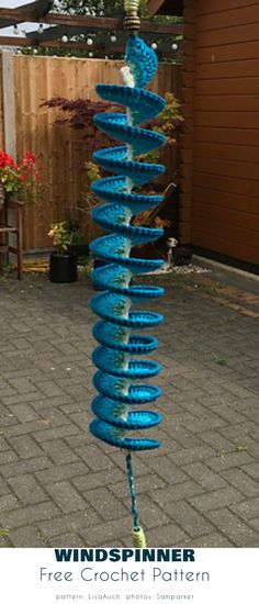 a blue wind spinner sitting on top of a brick patio