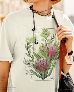 "This floral protea t-shirt is great for plant, flower, and garden lovers. Great gift for anyone who spends their time enjoying nurseries, plant shopping, and botanical gardens. FABRIC CONTENT:  - Fabric content varies based on color. Solid colors are 100% cotton, heather colors are 52% cotton/48% polyester, Athletic Heather and Black Heather are 90% cotton/10% polyester) - Light fabric (4.2 oz/yd² (142 g/m   FIT & CONSTRUCTION :  - Runs true to size (sizing runs slightly larger for women, as th Protea Flower Bouquet, Plant Shopping, Decor Drawing, Illustration Flower, Protea Flower, Floral Illustration, Plant Lover Gift, Plant Flower, Young T