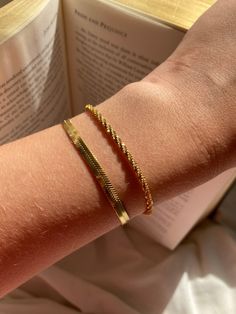 Set of two gold bracelets  Glow in gold with this bracelet stack, featuring our sparkly Rock chain, a new and unique design, made from rectangular links that are connected widthwise into a twisted row. Which creates a textured, tubular appearance with an excellent sparkle. The unique style creates a elegant, simple but statement bracelet  Stacked with our sleek and smooth herringbone bracelet, which is equally as dazzling with its reflective snake like design. Both made with plated stainless ste Unique Gold Bracelet Designs For Women, Trendy Snake Chain Bracelets As Gifts, Trendy Snake Chain Bracelet For Gifts, Gold Trendy Stackable Chain Bracelet, Trendy Gold Stackable Chain Bracelet, Rectangular Gold Plated Bracelets For Everyday, Everyday Rectangular Gold Plated Bracelets, Everyday Gold Plated Rectangular Bracelets, Trendy Tarnish Resistant Rectangular Bracelets