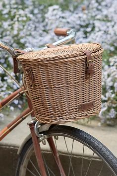 a wicker basket on the back of a bicycle