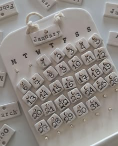 a close up of a keyboard made out of letters and numbers on a white surface