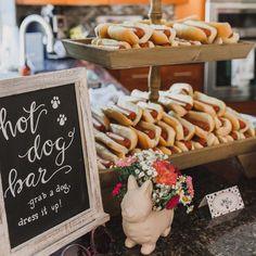 hot dogs and buns are on display at a dog themed brunch bar