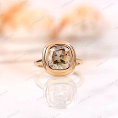 a gold ring with a brown diamond in it