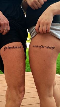 two people standing next to each other with tattoos on their butts and the words