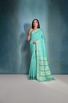 Fabric : Raw Silk Color : Turquoise Length : 5.5 Meter Saree + 0.80 Meter Blouse Saree Work : Ikkat Woven All Over Border : Zari Woven Border Wash : Dry Clean Only Product color may little differ as per the brightness or color settings of your device. Turquoise Saree With Zari Work For Navratri, Turquoise Chanderi Traditional Wear For Festivals, Turquoise Chanderi Traditional Wear For Festive Season, Semi-stitched Turquoise Saree With Dupatta, Unstitched Turquoise Saree, Turquoise Semi-stitched Saree With Dupatta, Festive Turquoise Saree In Traditional Drape, Turquoise Saree For Navratri Festive Occasion, Turquoise Saree For Navratri Festival