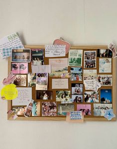 a bulletin board with many pictures and magnets on it