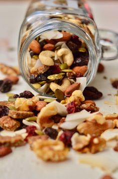 a jar filled with nuts and raisins on top of a table