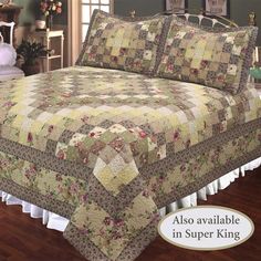 a bed covered in a green and brown quilted bedspread with white ruffles