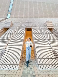 a woman standing in front of a tall building