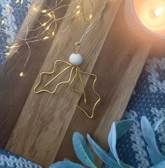 a wooden board with some lights on it and a candle next to it in the background