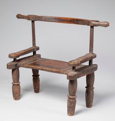 an old wooden chair sitting on top of a white floor