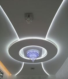 the ceiling is decorated with white lights and chandeliers, along with a circular light fixture