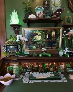 a desk topped with lots of green decorations