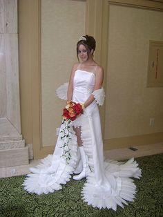 a woman in a white wedding gown holding a bouquet