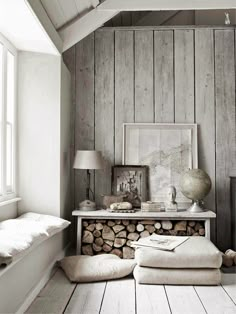 a room with wood stacked on top of each other and a lamp next to it