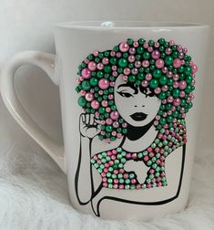 a coffee mug with beads on it and a woman's face